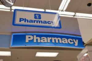 Close up of pharmacy sign hanging on store