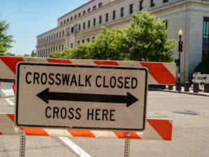 Crosswalk closed, cross here sign